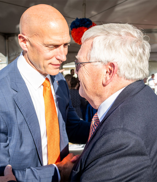Dr. John Coyne (right) greets Josh Whitman