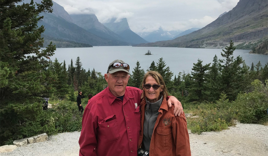 Dr. David Roffey and his wife, Maggie Murphy, by a mountain lake