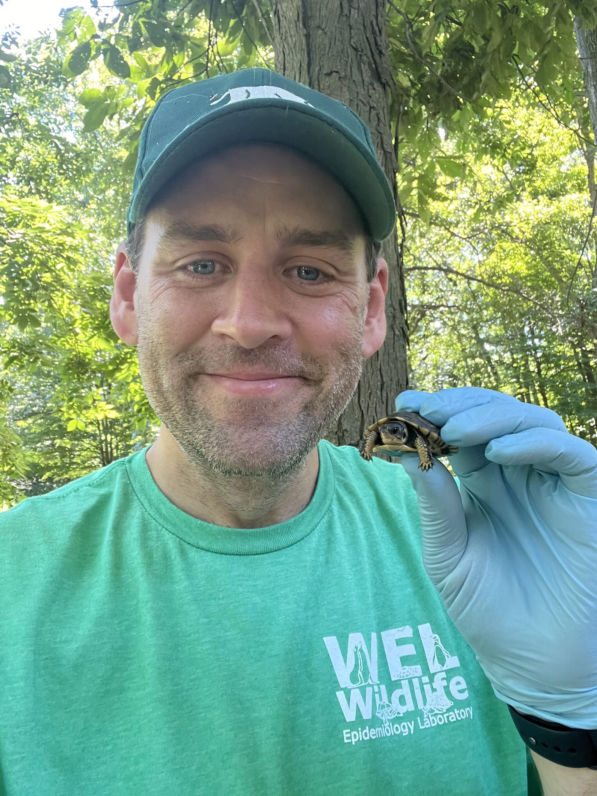 Matt Allender holding a small turtle.