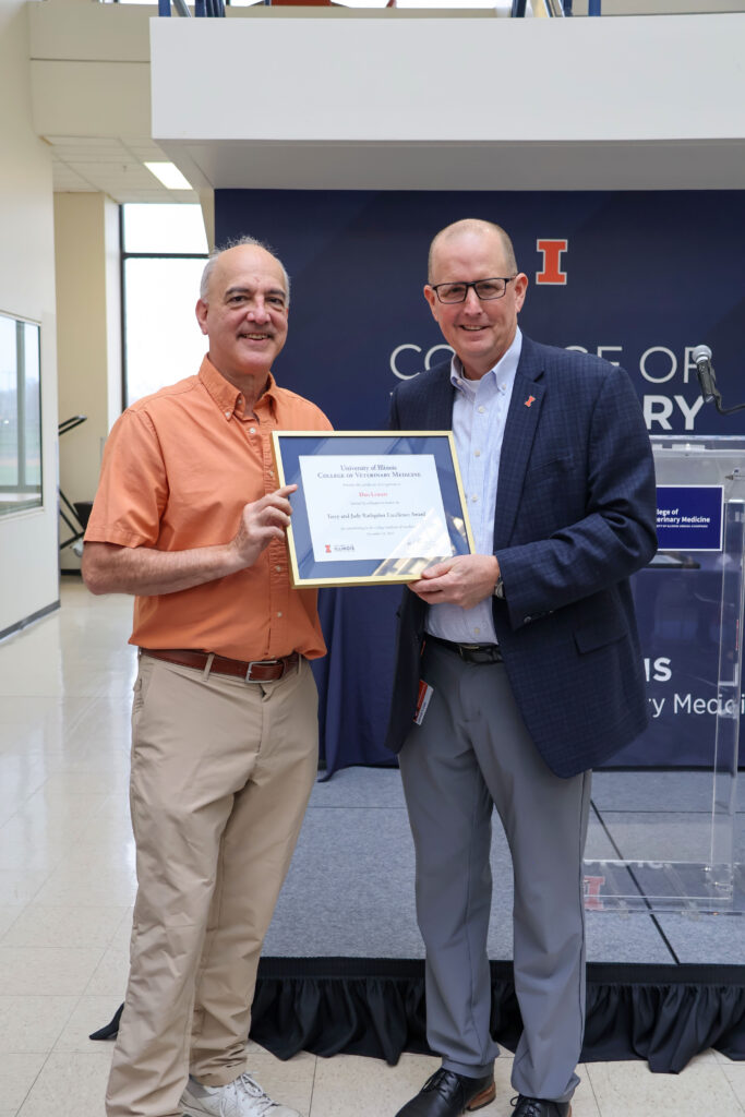 Dan Lewart receiving a college excellence award