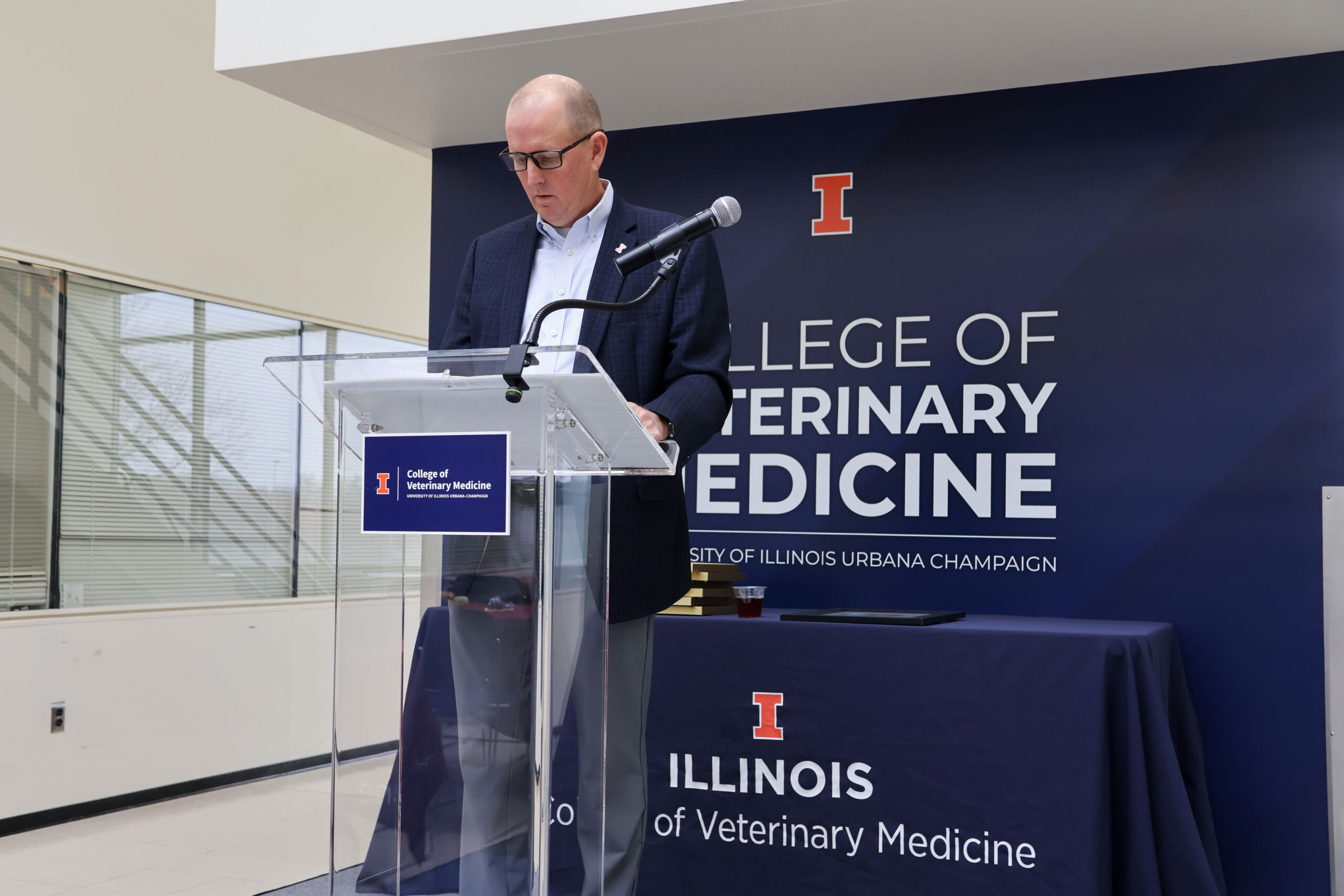 The presenter of the college excellence awards at the podium