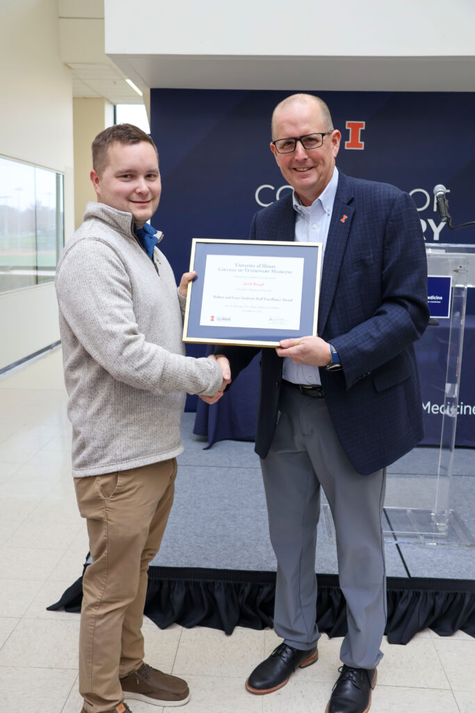 Jake Bough receiving a college excellence award