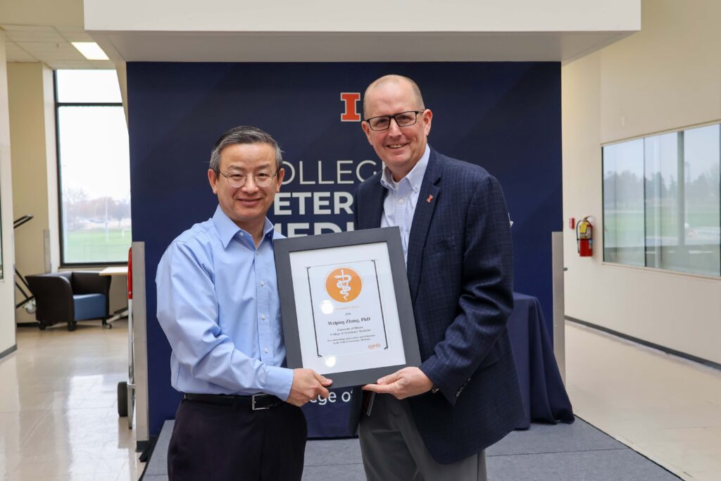 Weiping Zhang receiving a college excellence award