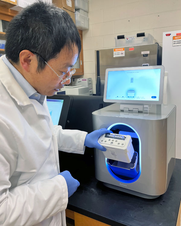 Dr. Leyi Wang operates a MiSeq i100 sequencer