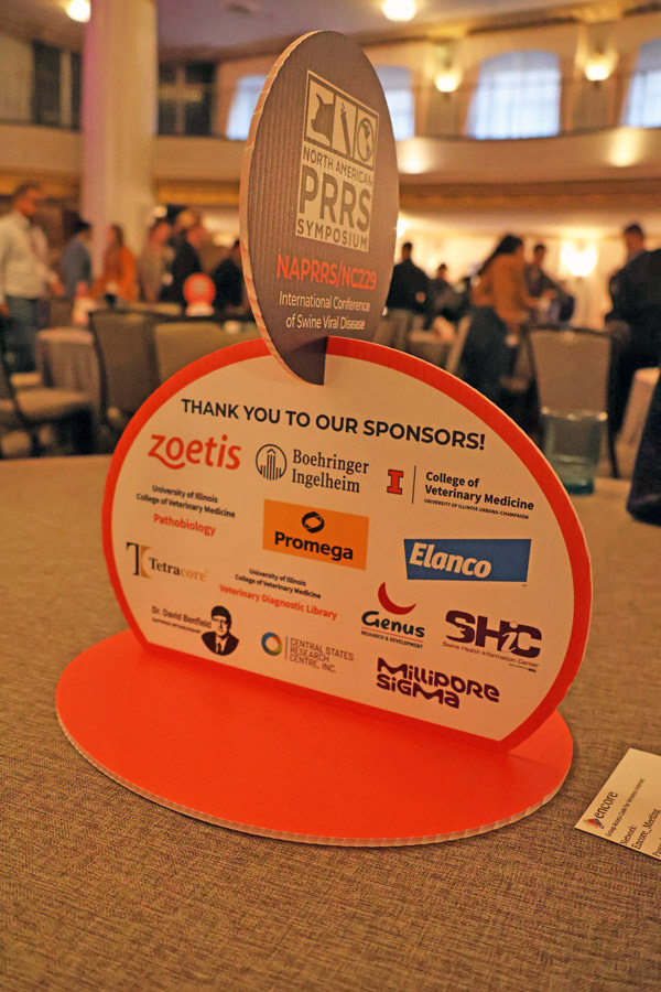 A cardboard cutout of the sponsors of the 2026 International Conference of Swine Viral Diseases