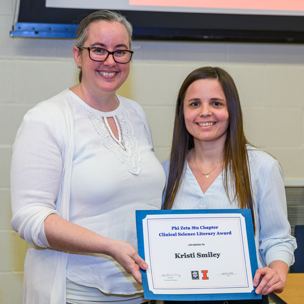 Dr. Miranda Vieson presents Kristi Smiley with a Literary Award