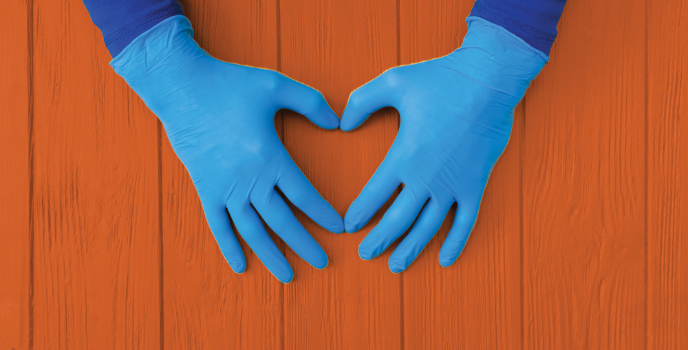 hands wearing blue nitrile gloves